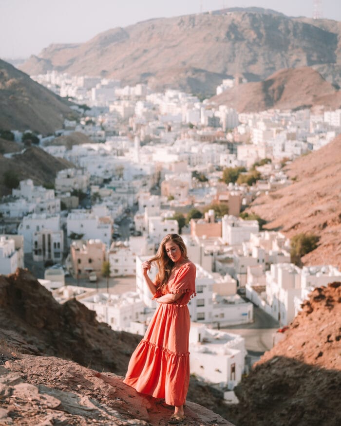 Michelle Halpern standing in front of a valley town of white houses in Oman