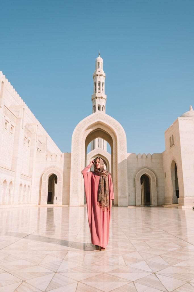 Michelle Halpern standing in front of the main archway at Sultan Qaboos Grand Mosque