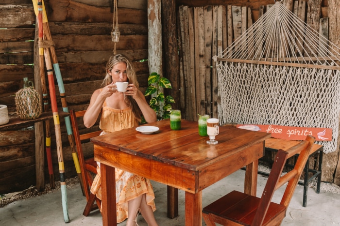 Michelle sipping a latte at a cafe in Bacalar, Mexico