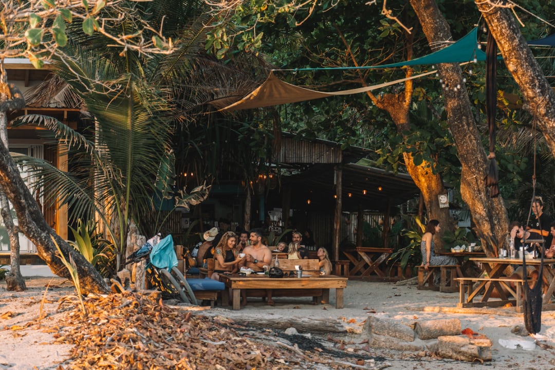 View from beach of the tables tucked into the jungle at Rocamar