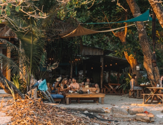 View from beach of the tables tucked into the jungle at Rocamar