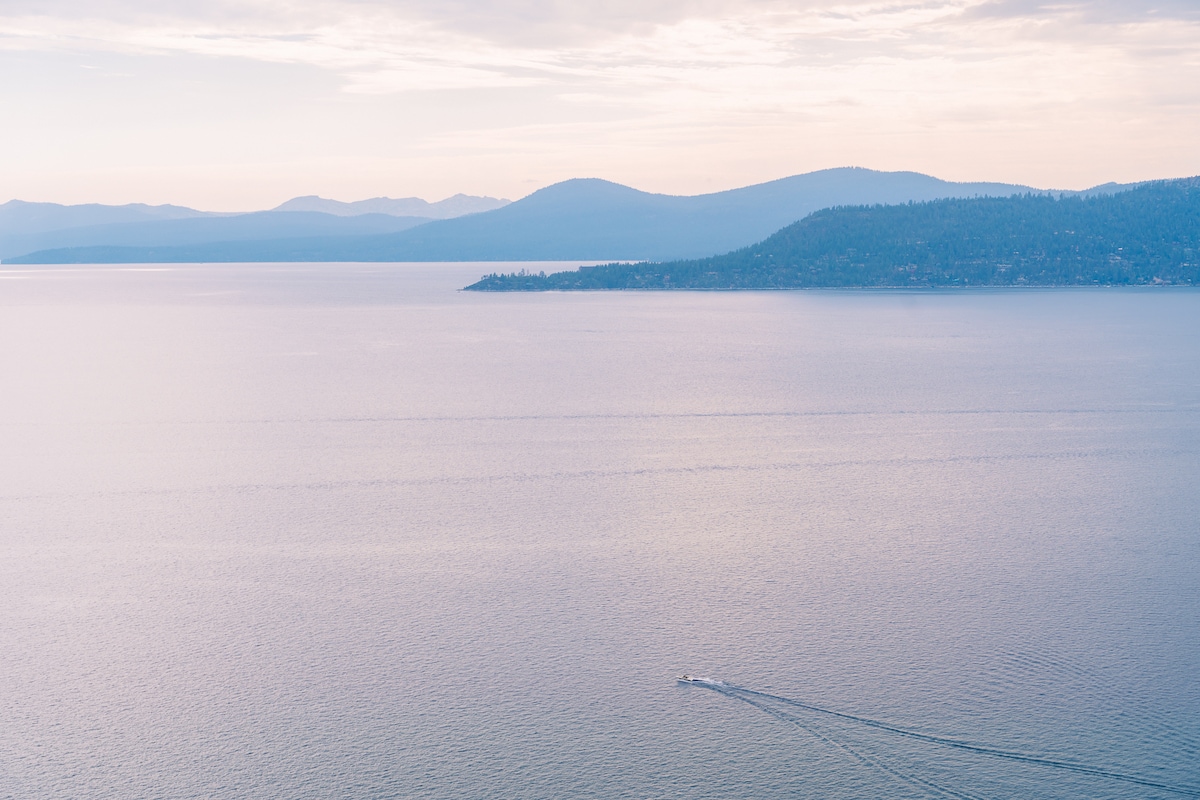 Boat riding out into the lake at sunset in Lake Tahoe