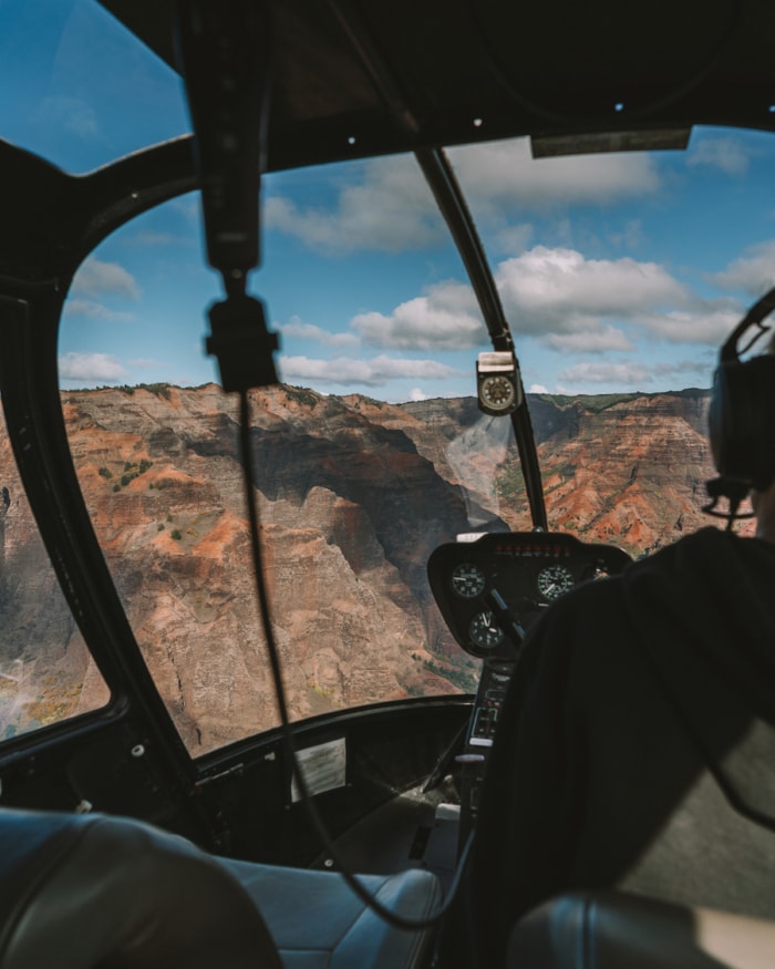 View from inside doors off helicopter tour in Kauai heading into Waimea Canyon