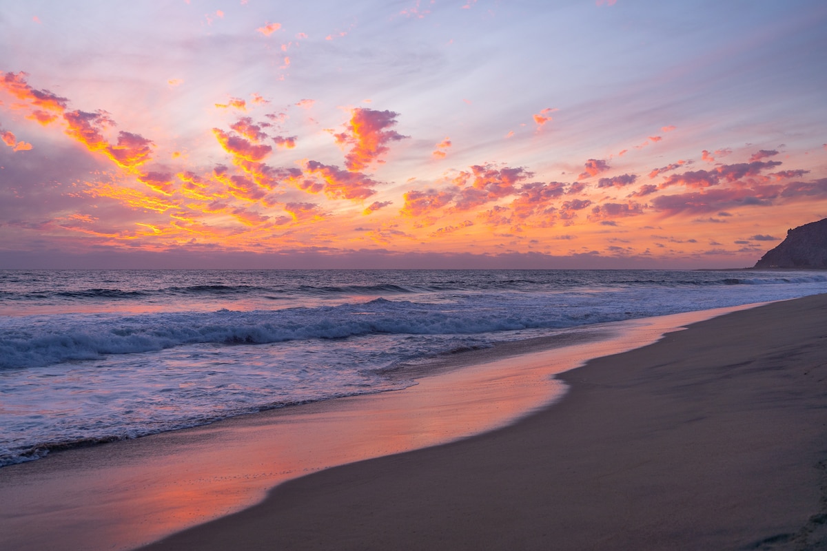 Vibrant orange and purple sunset at the beach in Todos Santos