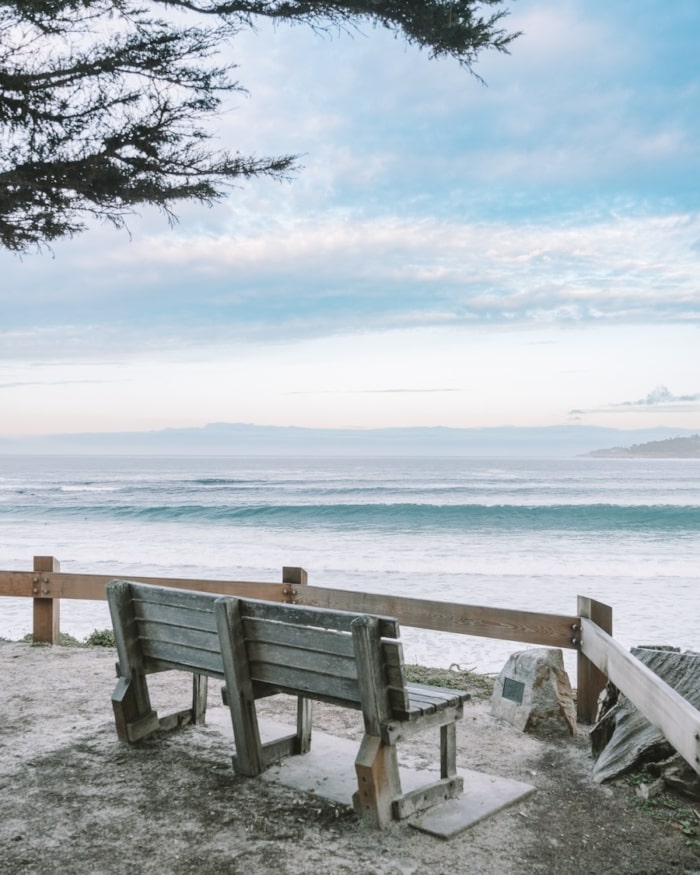 Empty park bench looking out over ocean in Carmel