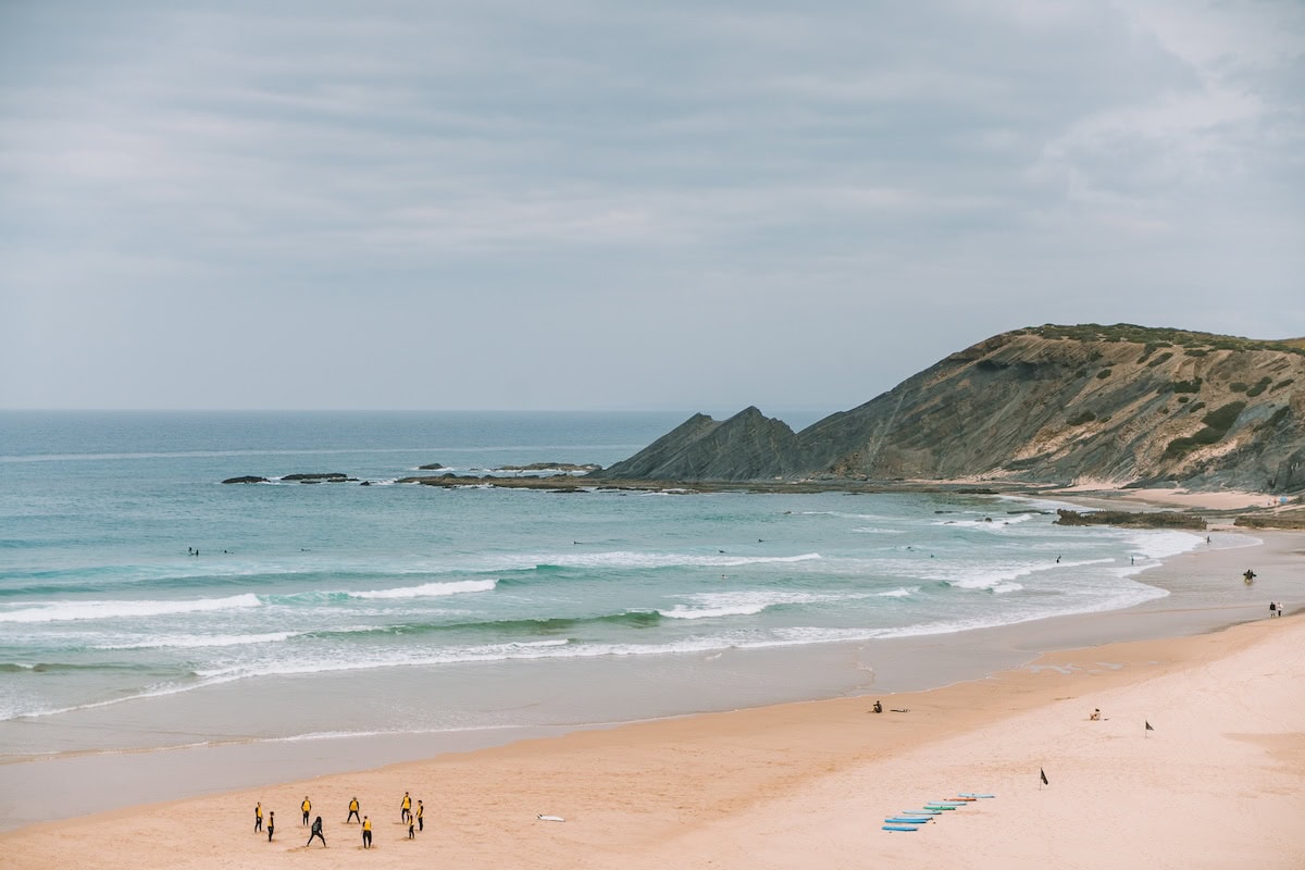 Surfers in surf school at Praia de Amoreira, Western Algarve