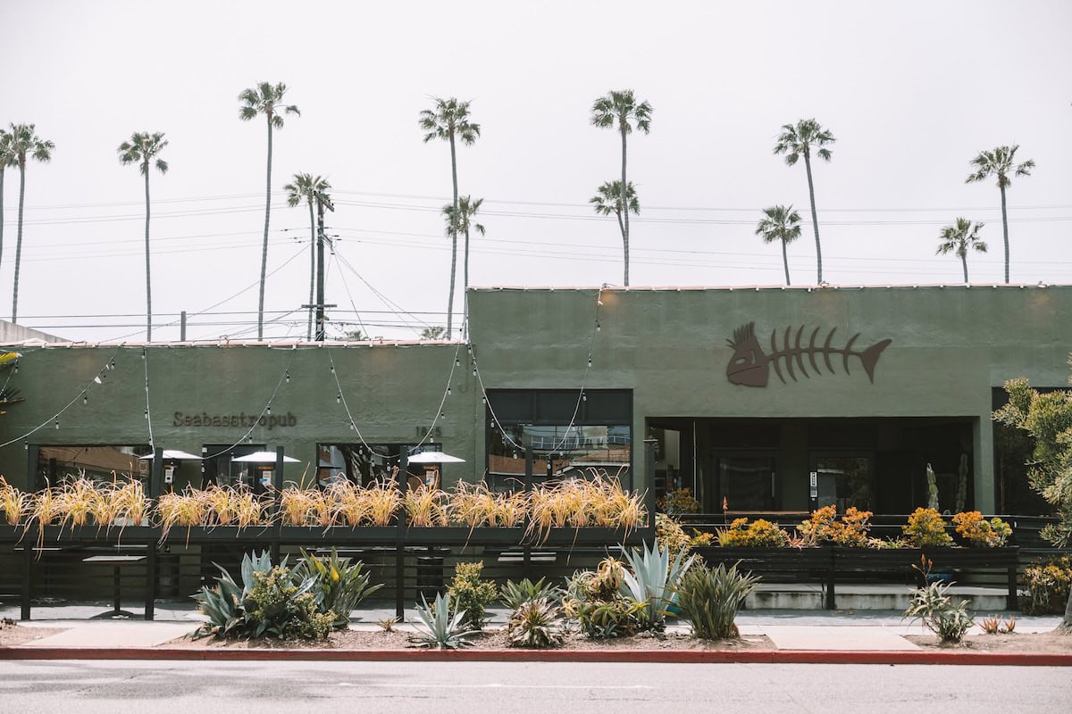 Exterior view of Wrench and Rodent which has a big fish motif in front, considered one of the best restaurants in Oceanside ca for seafood