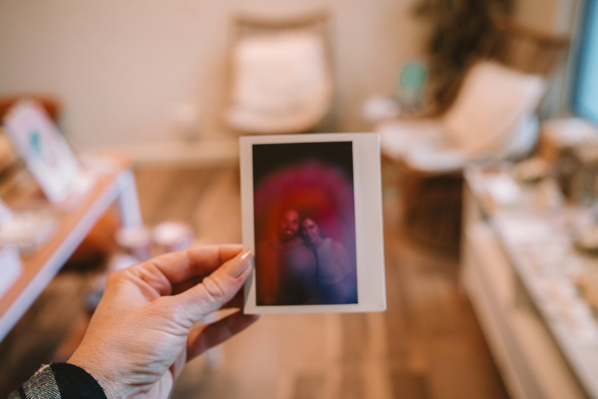 Hand holding up an aura reading photo