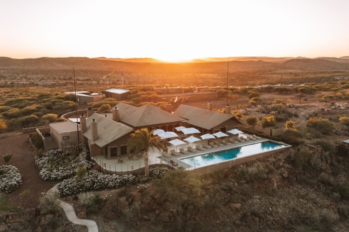 Drone shot of Gmundner Lodge at sunrise with golden rays
