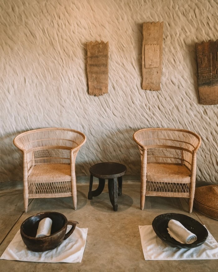 Two rattan chairs at the spa with bowls and towels placed in front
