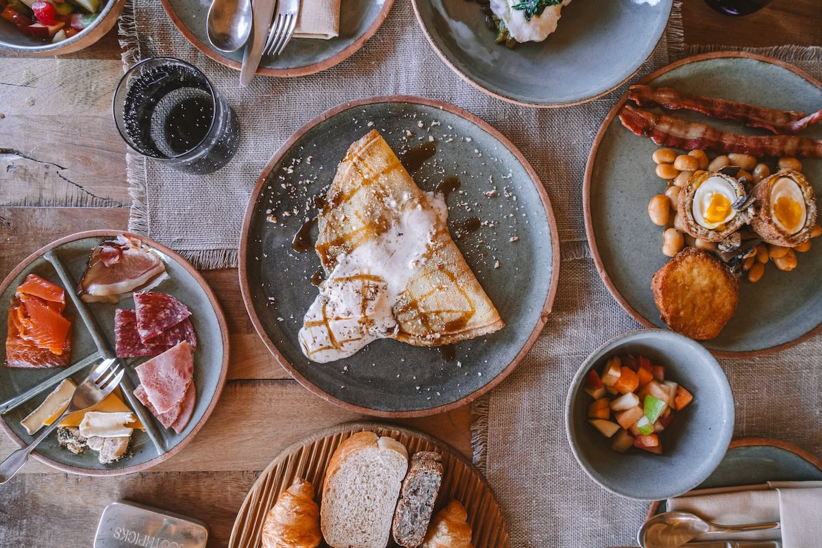 Top down view of breakfast spread including banana cream crepes