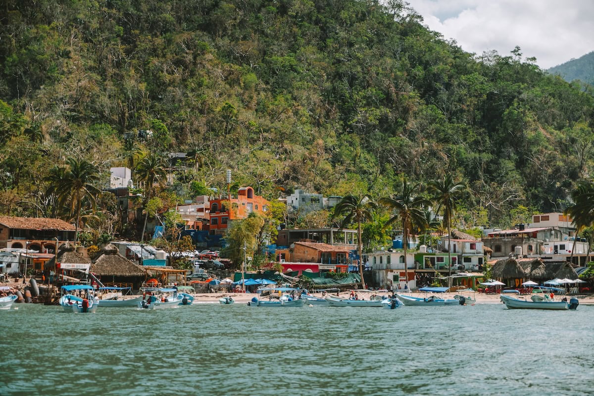 Bustling beachfront with tons of boats anchored at Boca de Tomatlán
