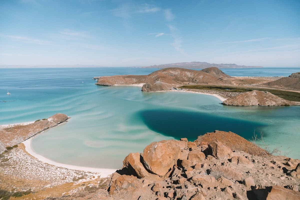 Wide angle view of the stunning orange rocks and turquoise way that contrast at Balandra Bay