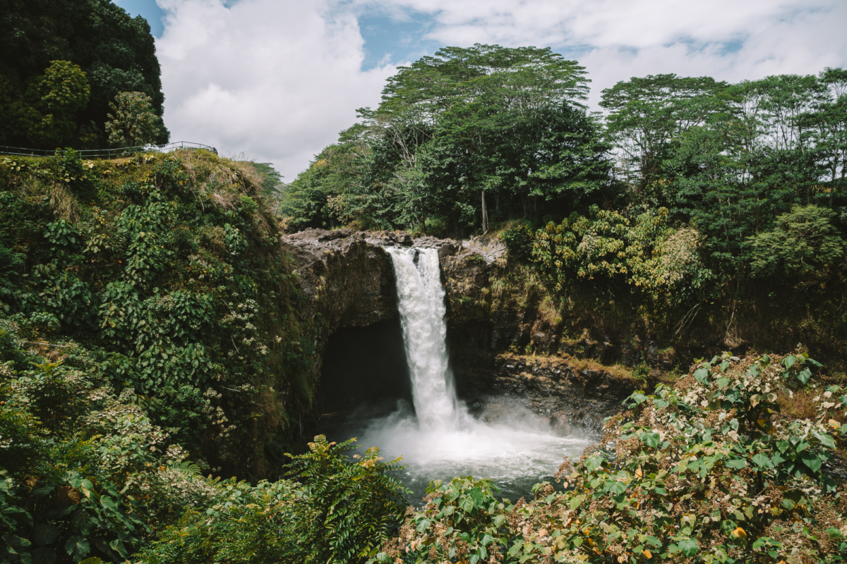 Rainbow Falls Overview image of Rainbow Falls in Big Island, Hawaii surrounded by lush greenery.