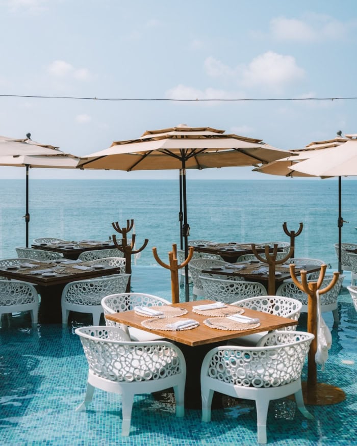 dining tables at Mar y Vino Straight on view of the dining tables at Mar y Vino that are inside of a pool overlooking the ocean.