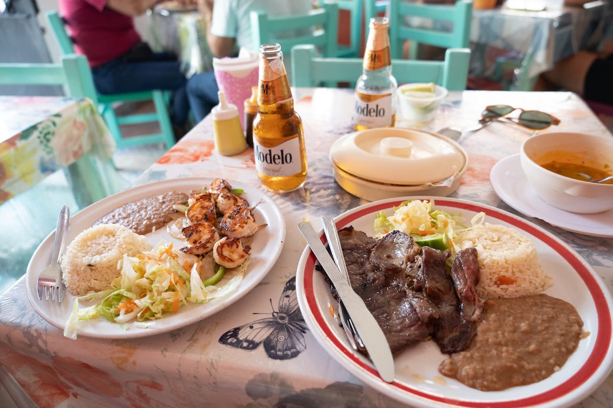 El Campanario food Simple dishes of meat, fish and beans Modelo beers on the table at El Campanario, one of the best restaurants in Puerto Vallarta Mexico