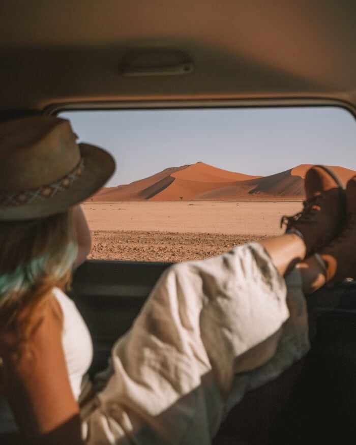 Michelle relaxing in the car gazing at the red sand dunes of Sossusvlei.