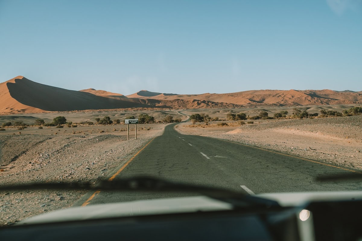 road through Sossusvlei View from dashboard out onto the road through Sossusvlei