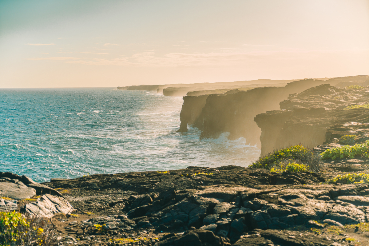 coastline cliffs Overview image of the ocean from the coastline cliffs with jagged cliffs jutting out into the ocean and waves crashing.