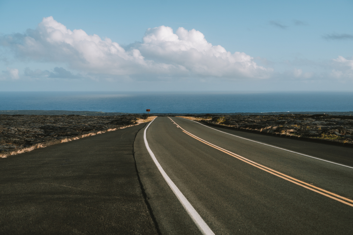 highway on the Big Island Straight stretch of highway on the Big Island, Hawaii leading toward the ocean.