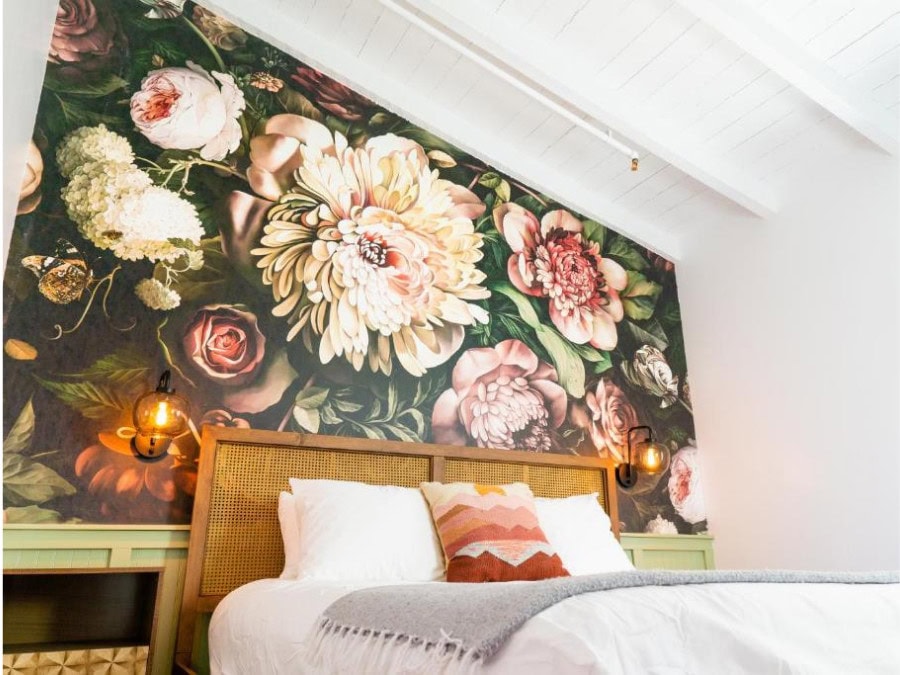 bedroom at Fleur Noire Image of a bedroom at Fleur Noire with a floral background wall.