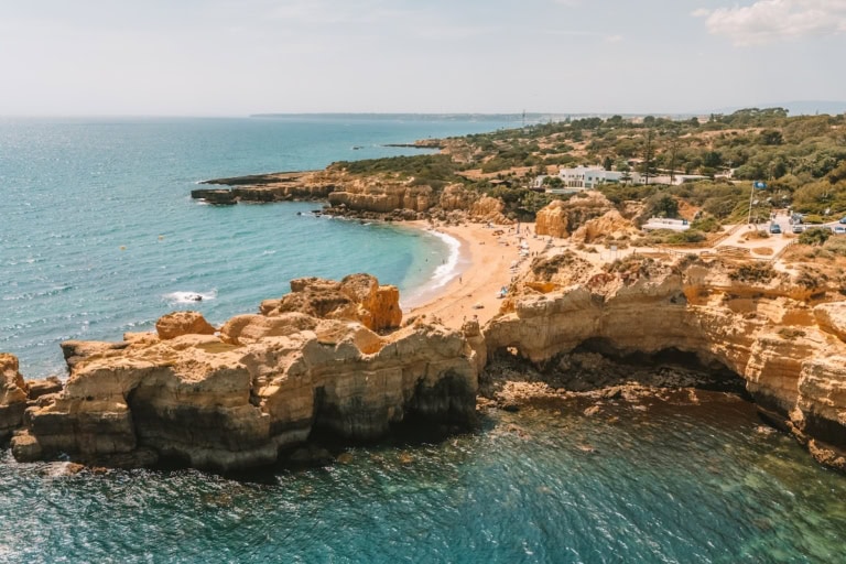 Drone shot above Castelo Beach and the adjoining rocky coast