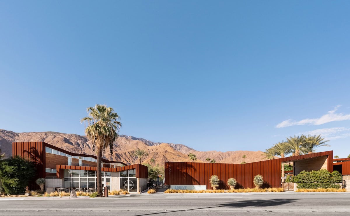 ARRIVE hotel in Palm Springs View of ARRIVE hotel in Palm Springs from across the street with Palm trees out front and the mountains as a backdrop.