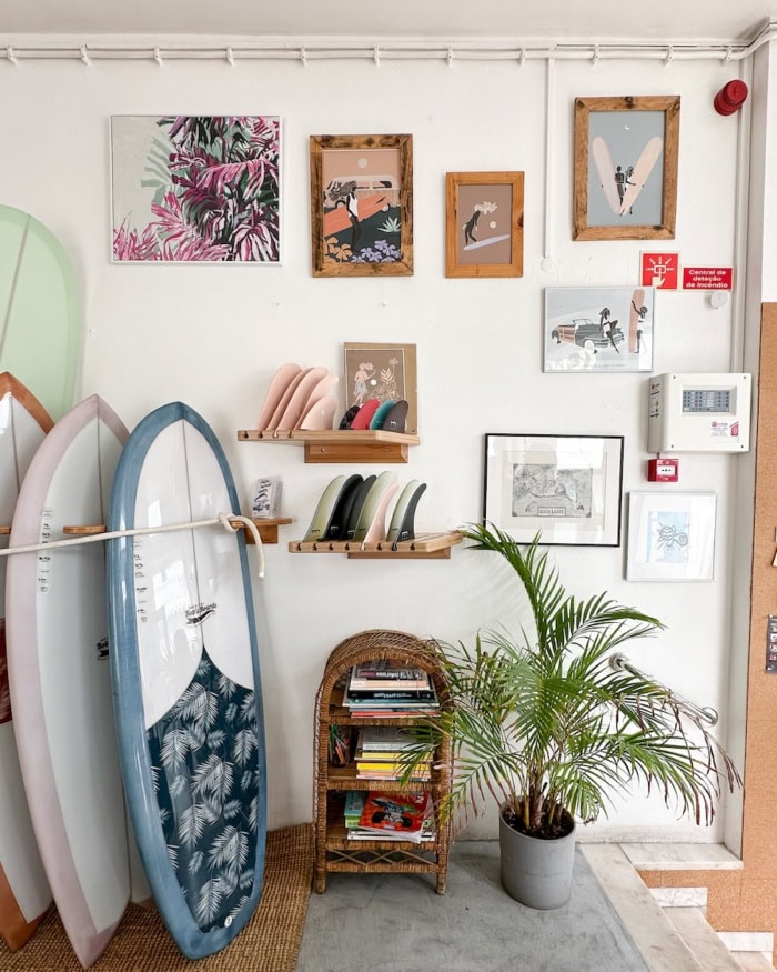 Coffee and Waves coffee shop Interior of Coffee and Waves coffee shop in Lagos, Portugal with a gallery wall and stack of surf boards as decor