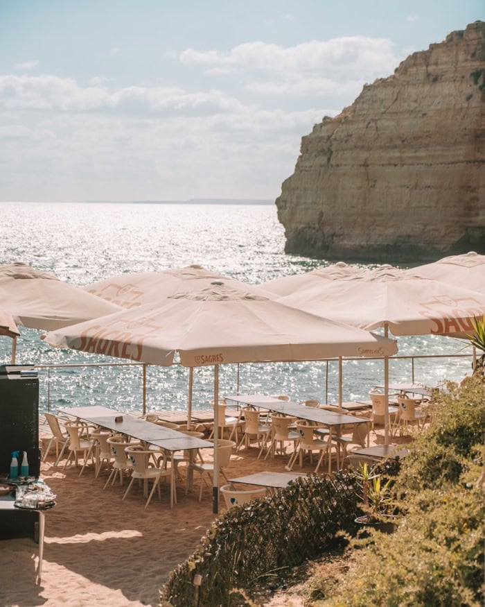 White tables and umbrellas Algarve Portugal Itinerary