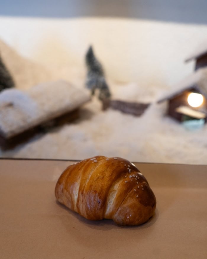 One piece of salt bread sitting on a table.