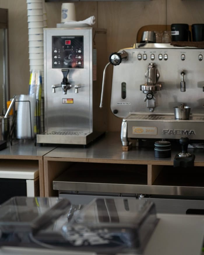 Stereophonic Sound seoul Professional barista equipment in the background and a record player in the foreground.
