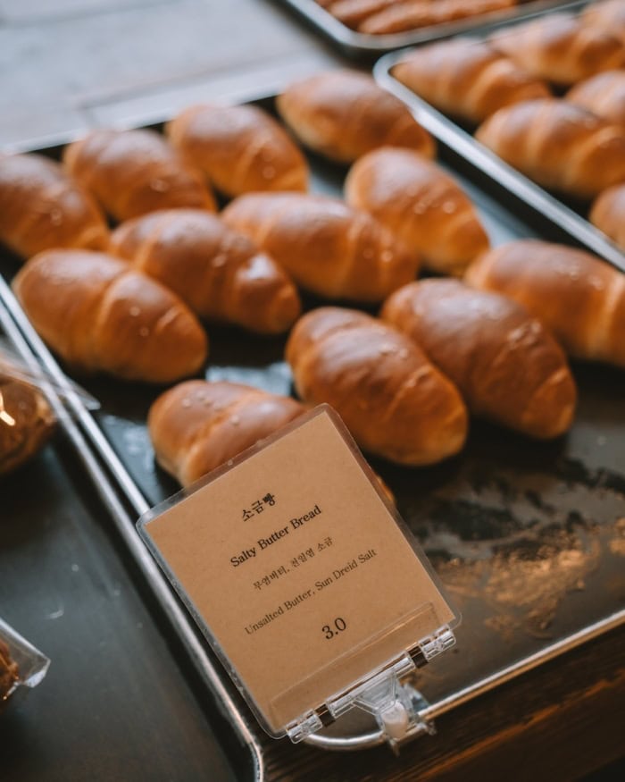 Salty butter bread Salty butter bread on a tray and a sign that explains what it is in Korean and English
