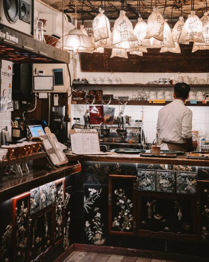 Interior of Coffee Hanyakbang Interior of Coffee Hanyakbang showcasing baristas making coffee in a room with an old school Korean decor feel
