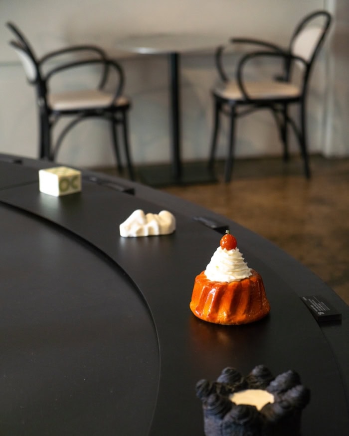 Nudake cake Creatively designed table of cakes set up on a big round black table