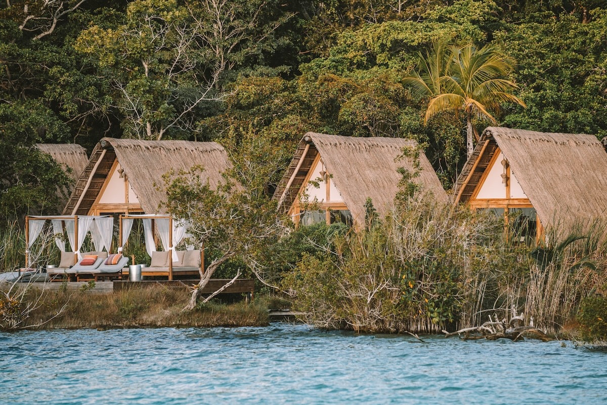 Three huts Three huts lined up with the lagoon in the foreground