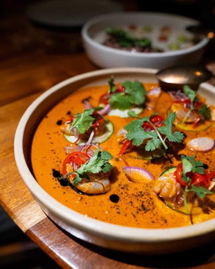 orange shrimp aguachile dish Up close shot of an orange shrimp aguachile dish
