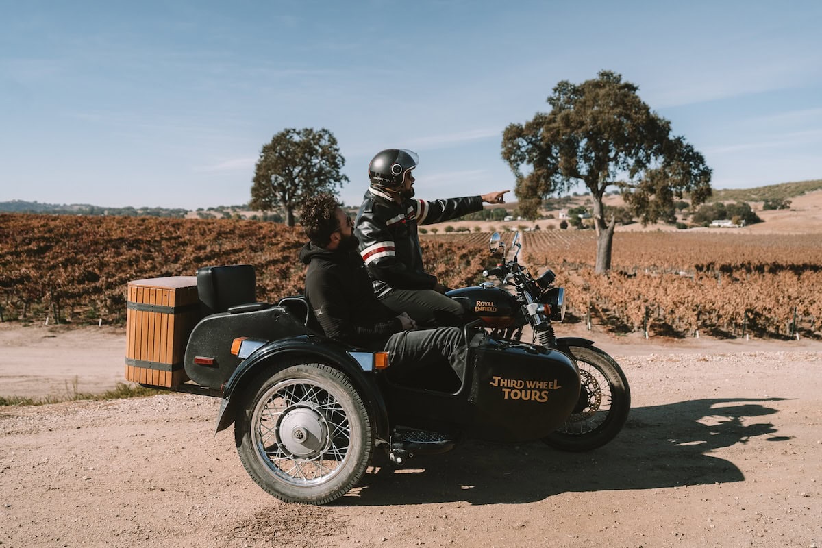 vintage sidecar Two men sitting in a vintage sidecar looking out onto the vineyards at Cass Winery in Paso Robles - Third Wheel Tours