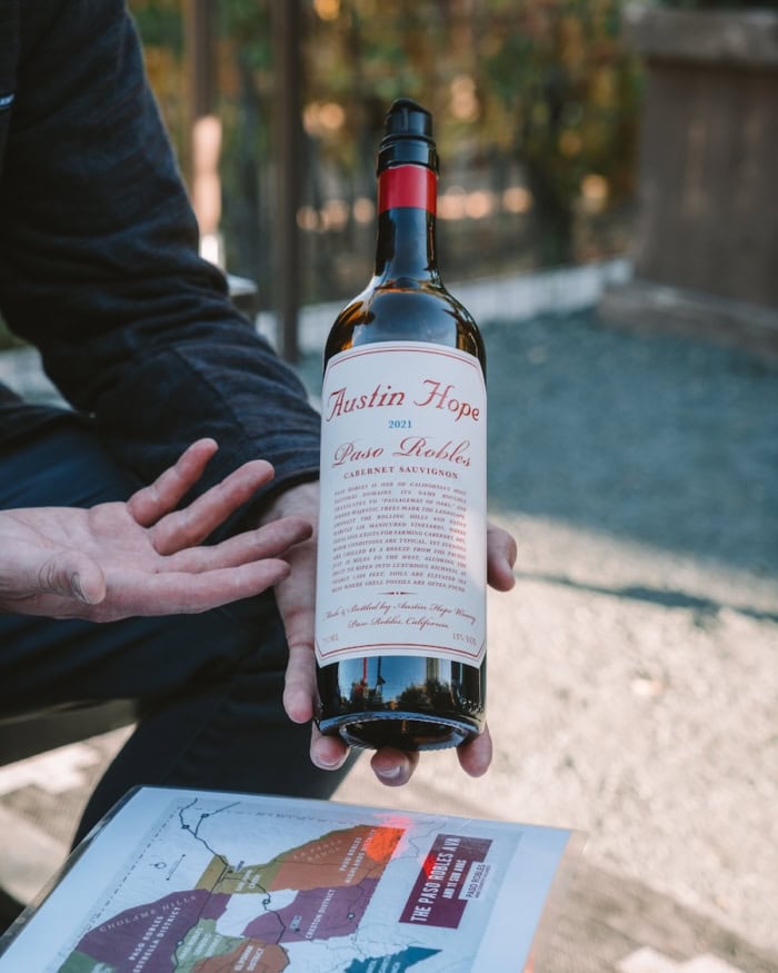 Austin Hope Winery Man holding up a bottle of cabernet sauvignon from Austin Hope winery in Paso Robles