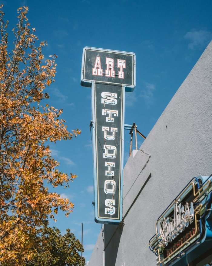 Art Studios Vintage sign against a blue sky that reads "Art Studios"
