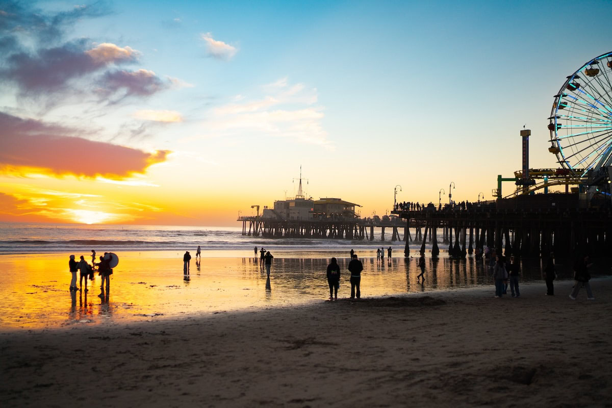 Santa Monica Beach The sunset reflecting in the water at Santa Monica Beach with the Santa Monica Pier and ferris wheel in the background