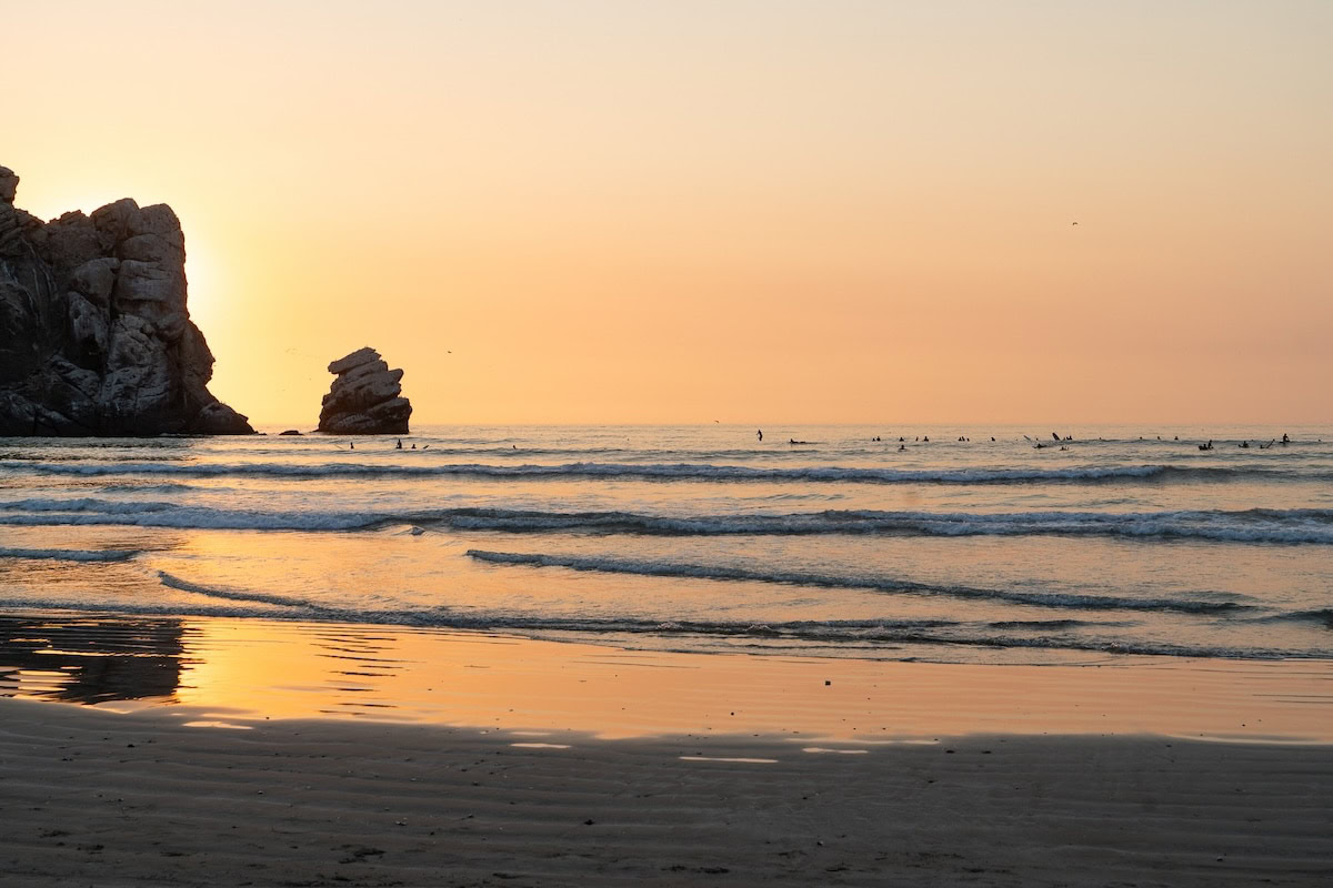 Sunset at Morro Rock Beach Sunset at Morro Rock Beach with the water mirroring the orange hues of the sky.