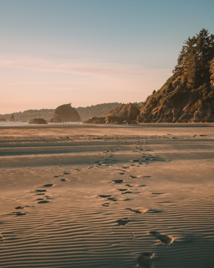 sea stacks on Moonstone Beach Footprints in the rippled sand walking towards the sea stacks on Moonstone Beach