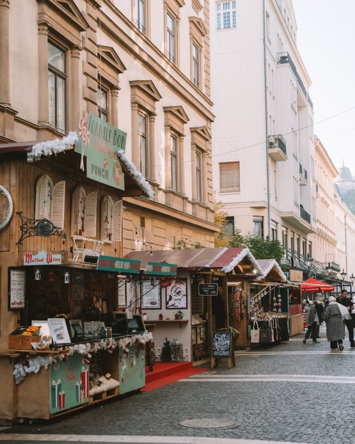 Cobblestone street with vendors Cobblestone street lined with Christmas Market vendors including a mulled wine hut