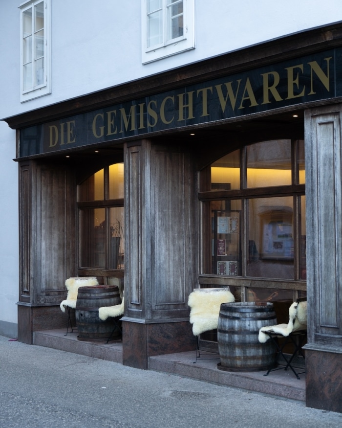 restaurant in Hallstatt Restaurant with outdoor seating including barrel tables and sheepskin covered chairs