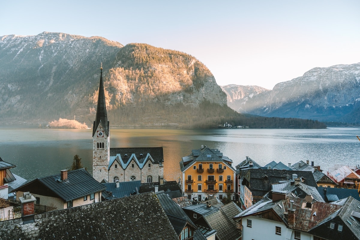 lake in Hallstatt Light starting to peek over the mountains and shine on the lake in Hallstatt