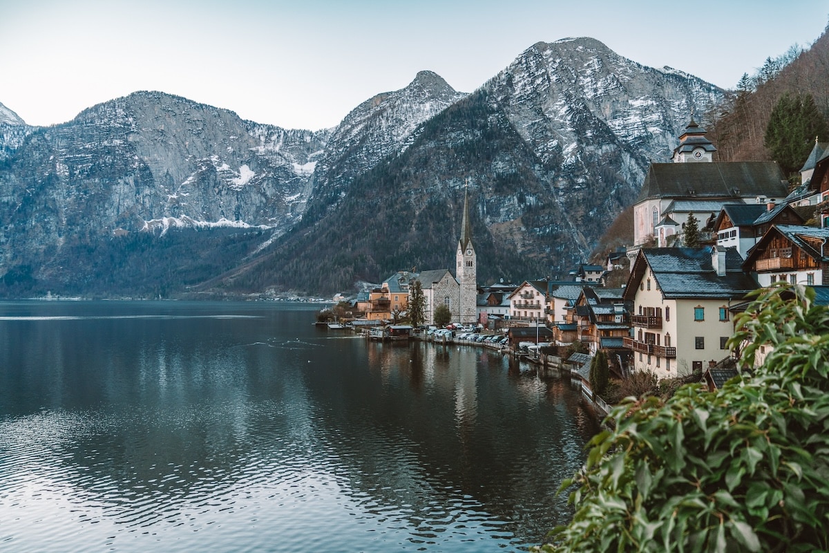Hallstatt Austria church View from afar of the main church in Hallstatt, Austria and surrounding town with mountains in the background