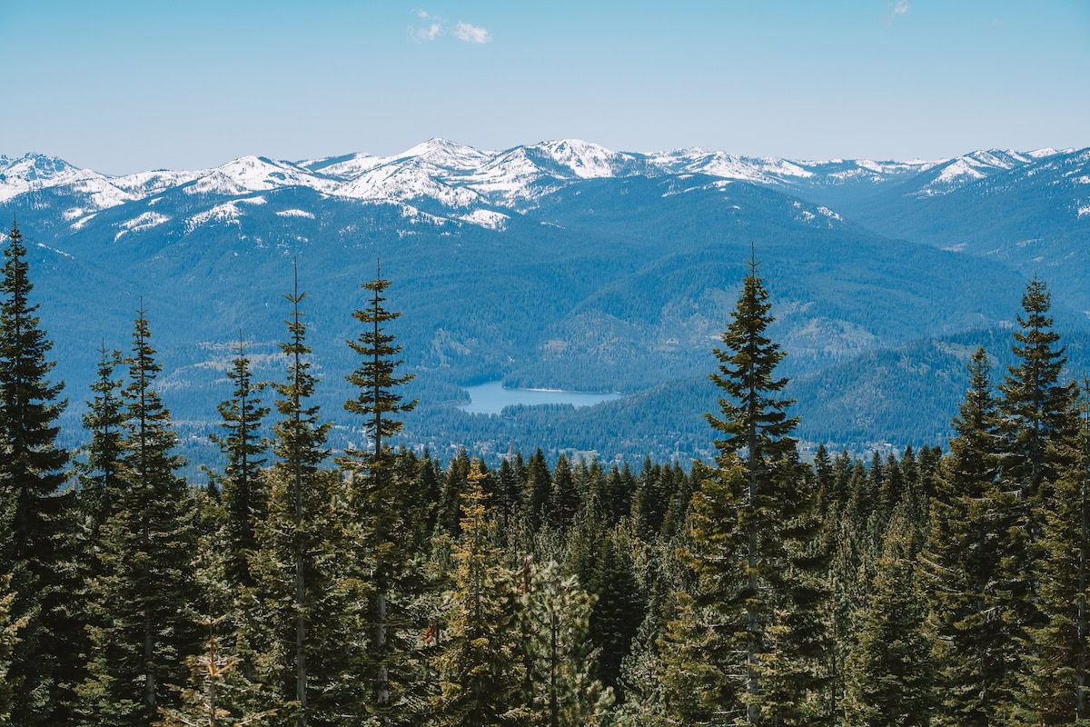 alpine lakes snowcapped mountains Scenic view of a forest in the foreground, alpine lakes and snowcapped mountains in the background
