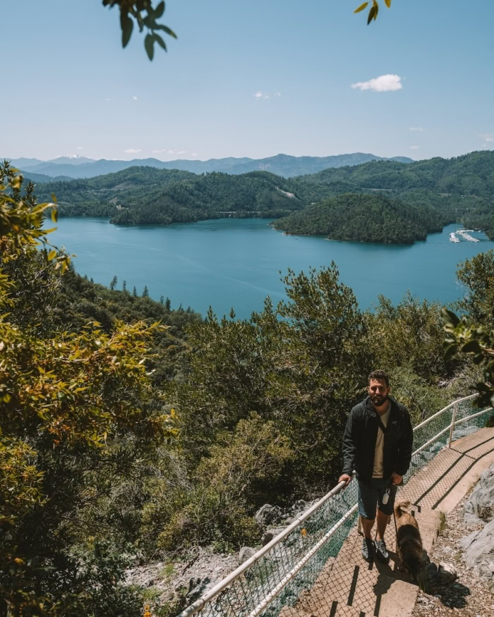 Lake Shasta Caverns path JT, Michelle's husband, standing on the path out of Lake Shasta Caverns with a beautiful view of Lake Shasta behind him