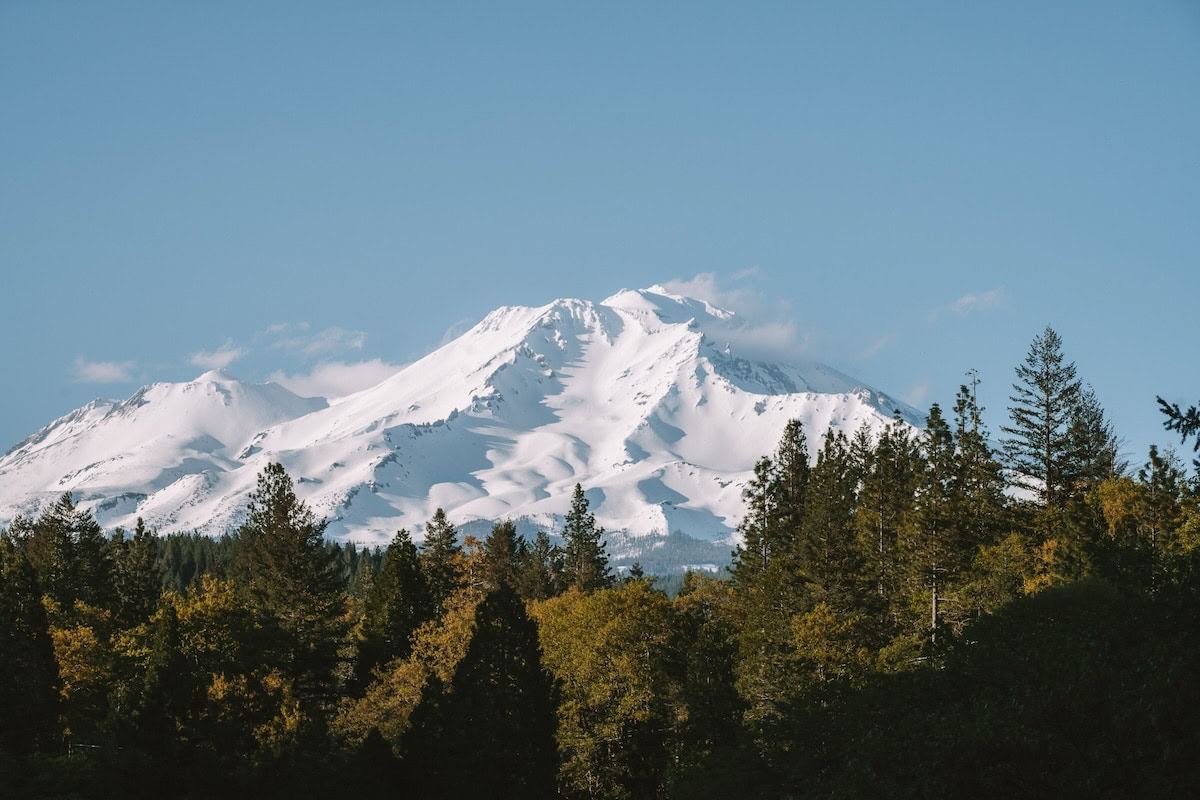 Mount Shasta snow Perspective of Mount Shasta during the daytime with snow on the peak and clouds coming off of it