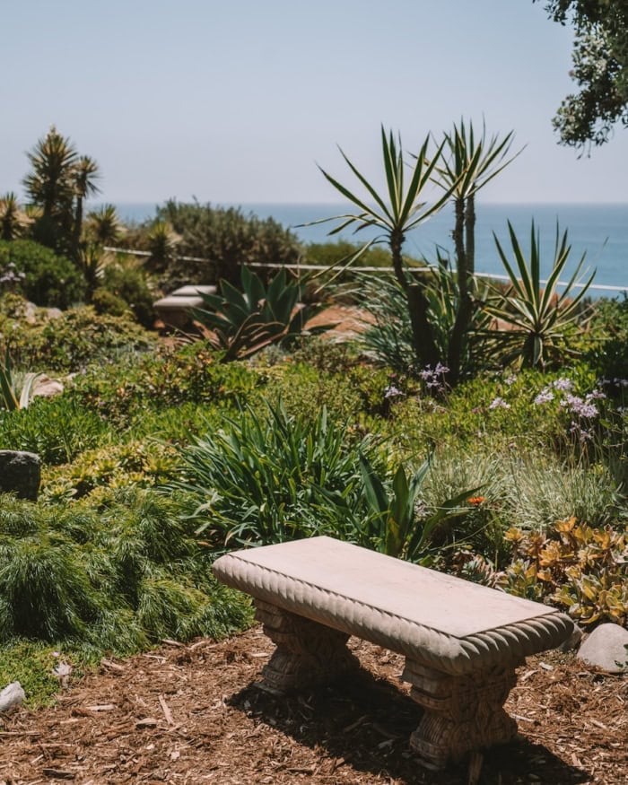 Stone bench Stone bench set amongst greenery that overlooks the ocean in Encinitas at the Swami's Meditation Gardens
